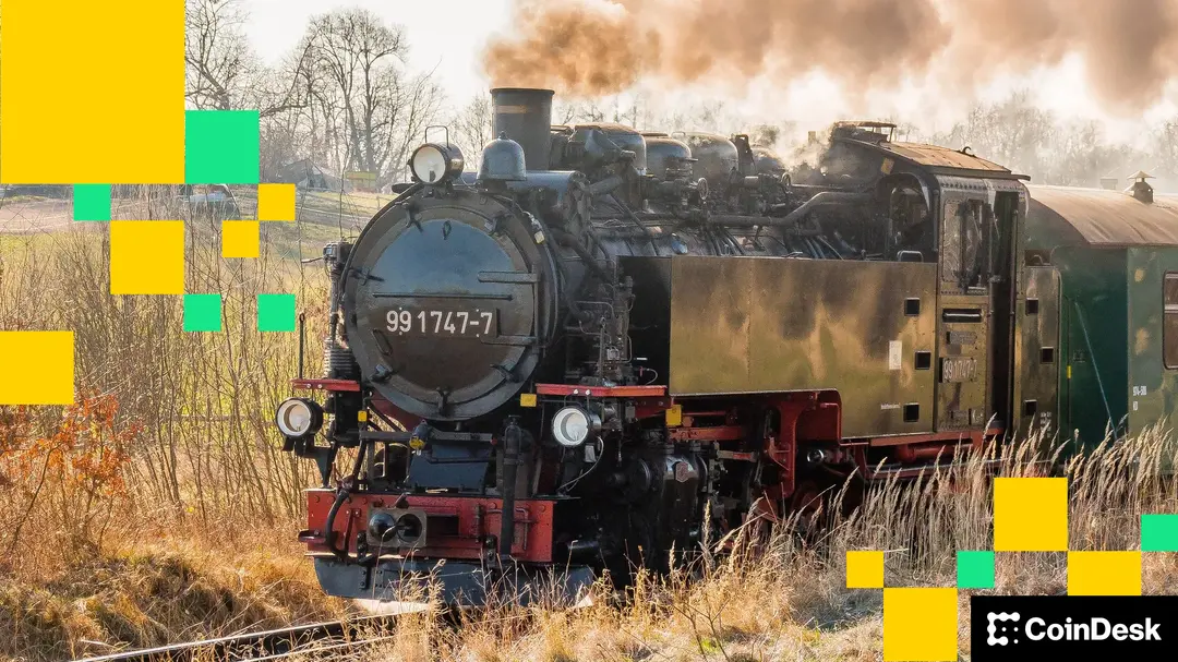 A locomotive belches steam as it powers through the countryside.