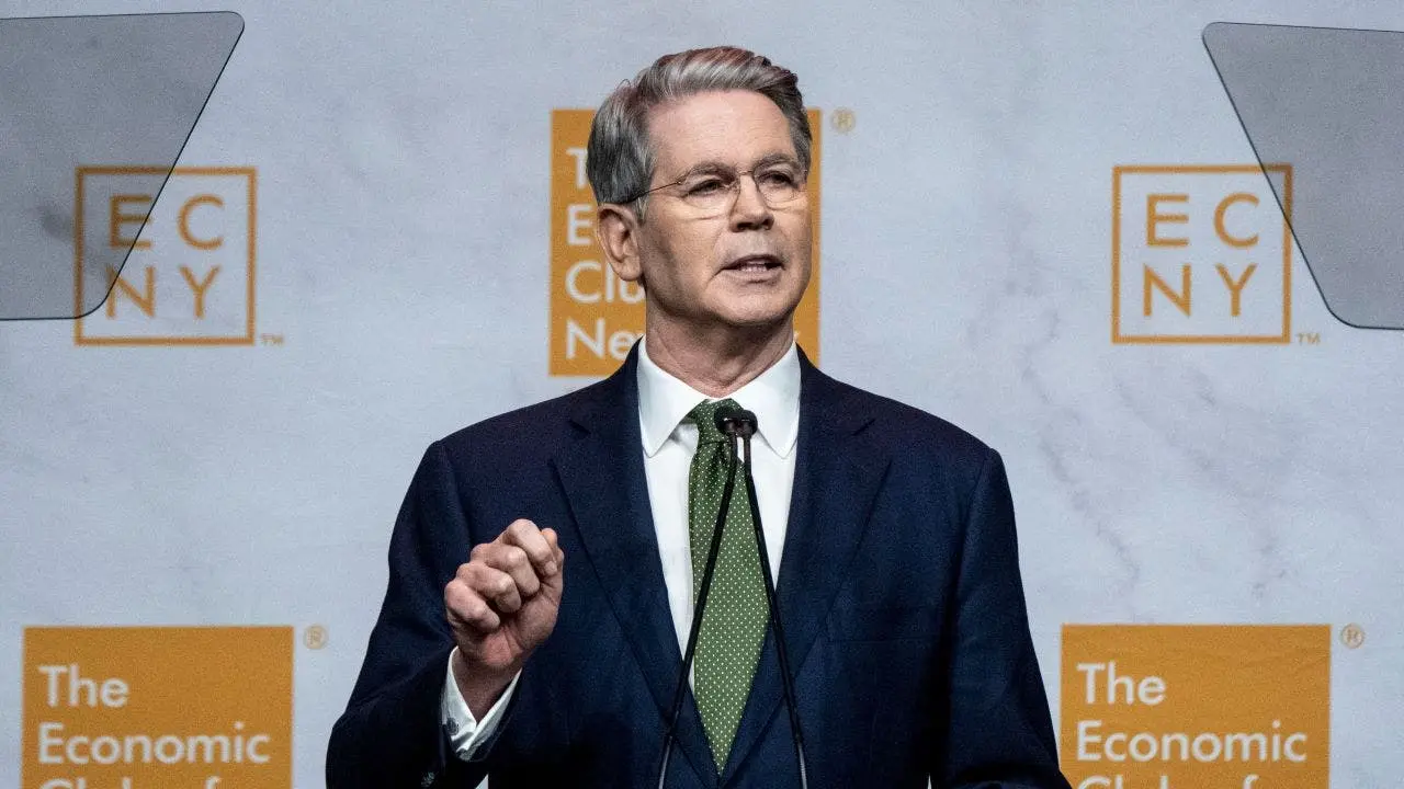Scott Bessent speaking at a podium in front of a The Economic Club of New York backdrop