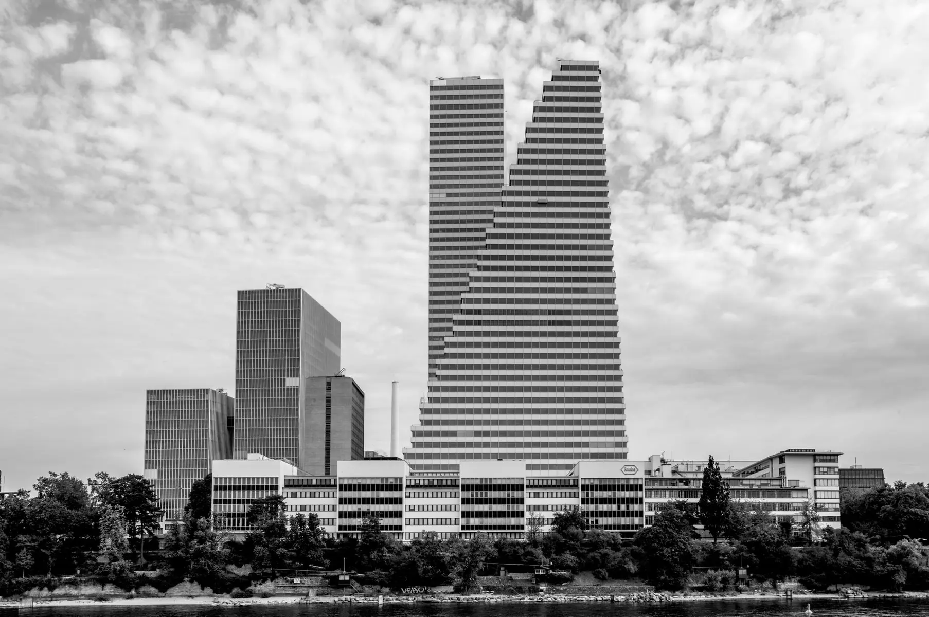 Black and white wide shot of the UBS headquarters building in Zurich with its distinctive stepped architecture.