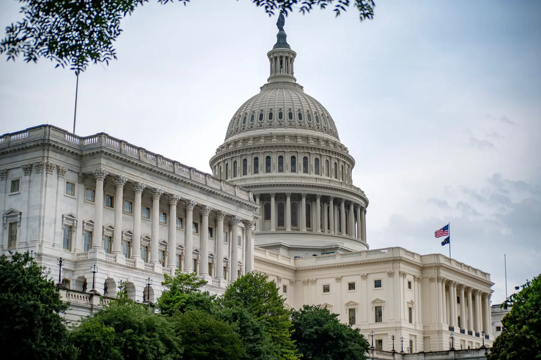 The exterior of the United States Capitol building in Washington, D.C., featuring the grand dome and white columns.