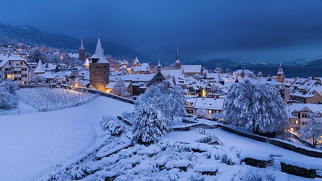 Night falls over buildings in the Swiss canton of Zug.