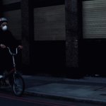 man in black jacket riding on bicycle