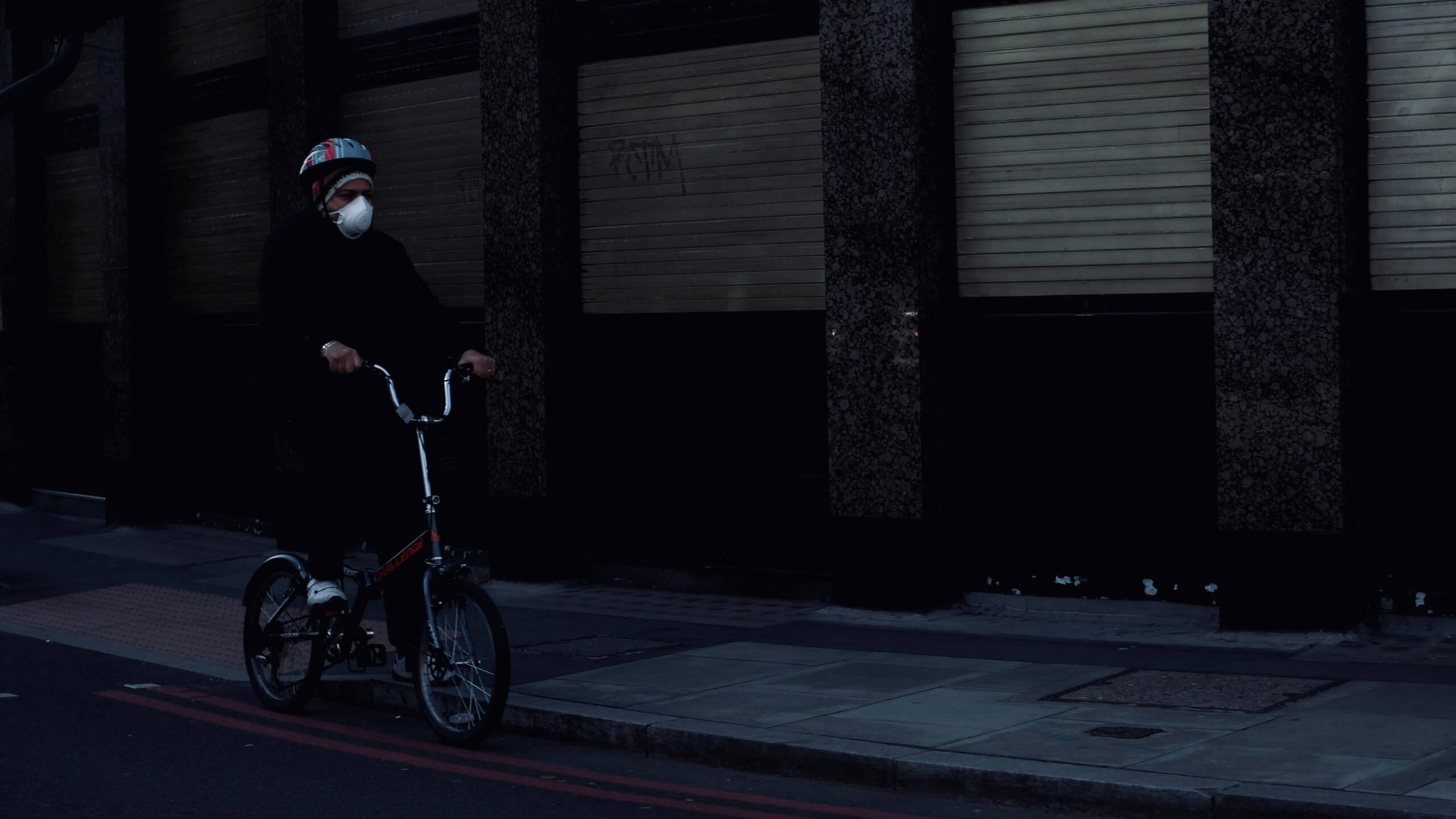 man in black jacket riding on bicycle