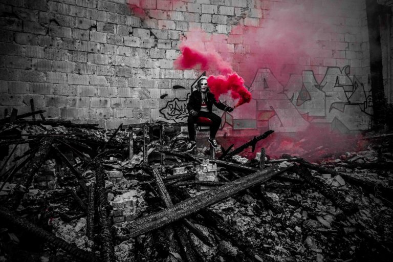 selective photography of person holding smoke with red color