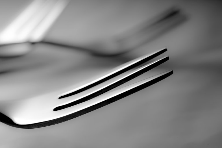 stainless steel fork on white paper