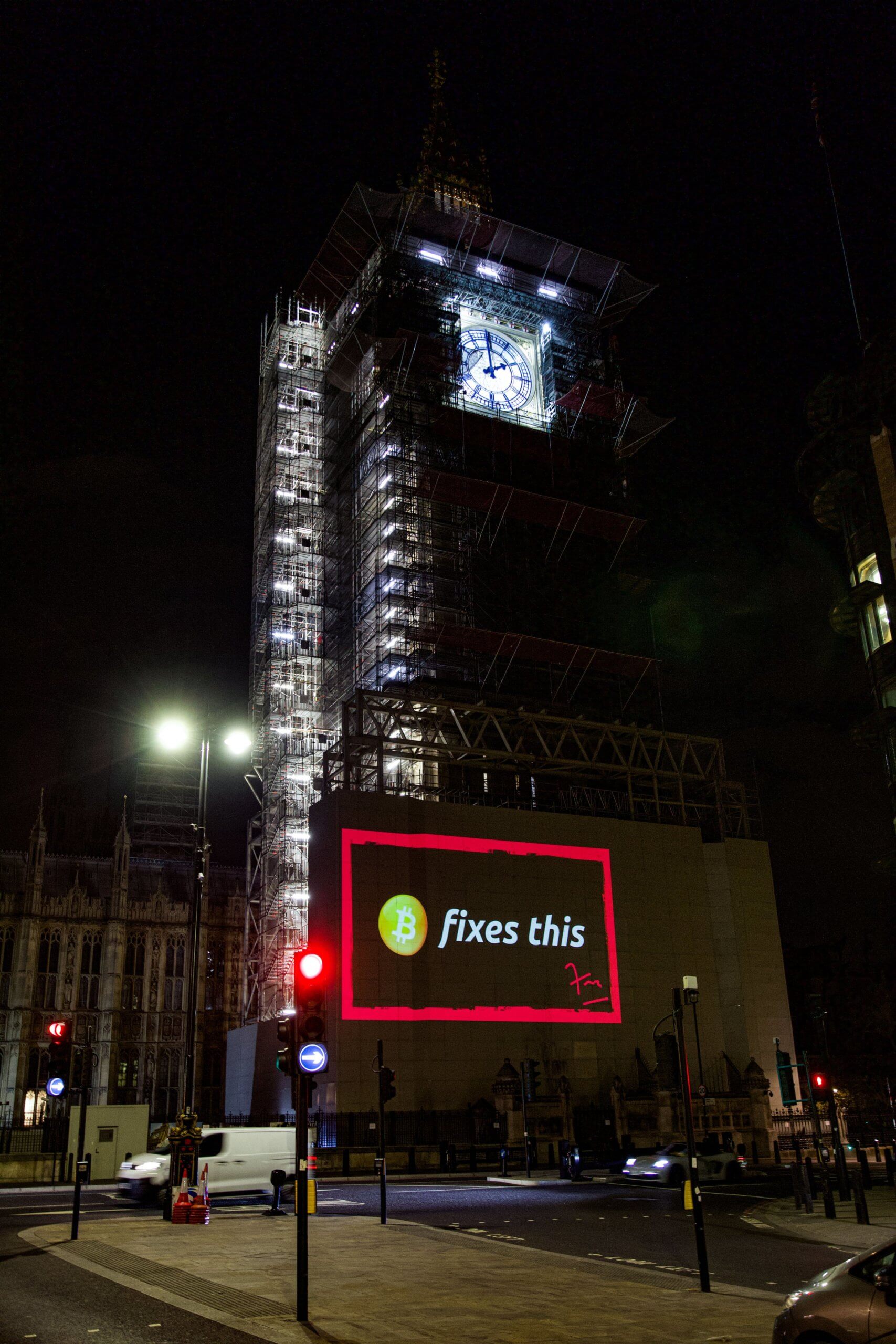 "Bitcoin fixes this" projected on the Parliament building in London