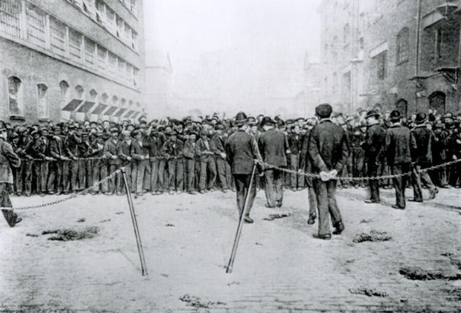London dockland workers standing on the stones.