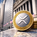 A large XRP coin stands on Wall Street with stacked tokens behind it, reflecting growing institutional interest as XRP spot ETFs surpass $1B in assets.