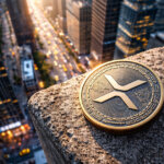 A large XRP coin rests on a high-rise ledge overlooking a busy cityscape at sunset, symbolizing XRP’s surge as the best-performing institutional crypto asset in late 2025.