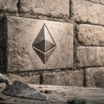 An Ethereum symbol carved into stone blocks like ancient masonry illustrates why Ethereum’s future may rely on adopting Bitcoin’s proven principles of durability and trust