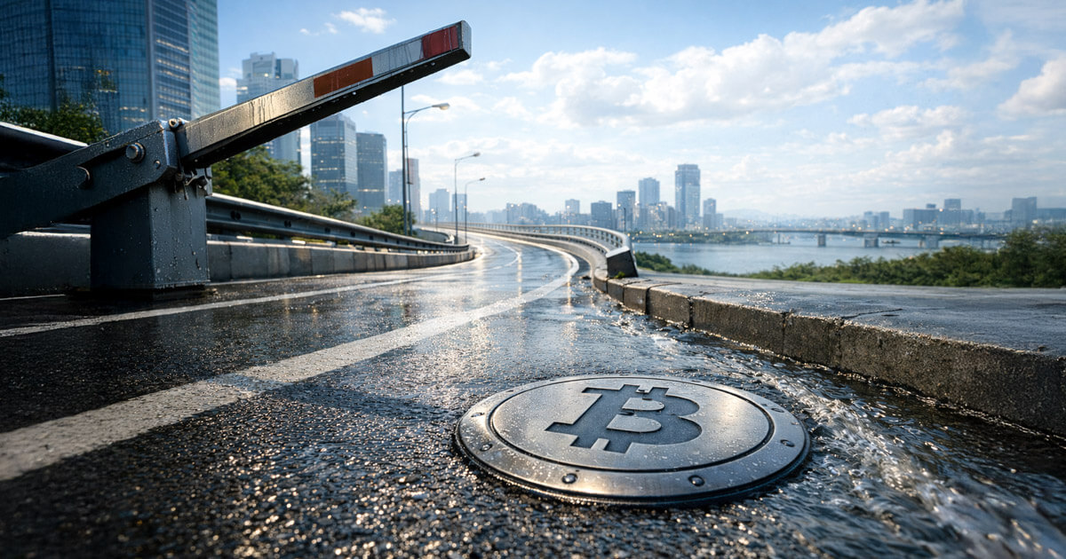 A Bitcoin symbol embedded in a wet roadway near a raised barrier and city skyline illustrates South Korea lifting its corporate crypto ban while forcing firms to sell holdings first