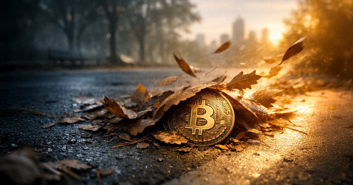 Bitcoin coin half-buried under autumn leaves on a wet path at sunrise, symbolizing a Bitcoin bear market nearing its end as key signals begin to flip.
