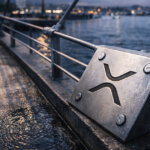 XRP logo plate bolted to bridge cables at dusk, symbolizing XRP network health across wallets, trustlines, DEX volume, and uptime performance