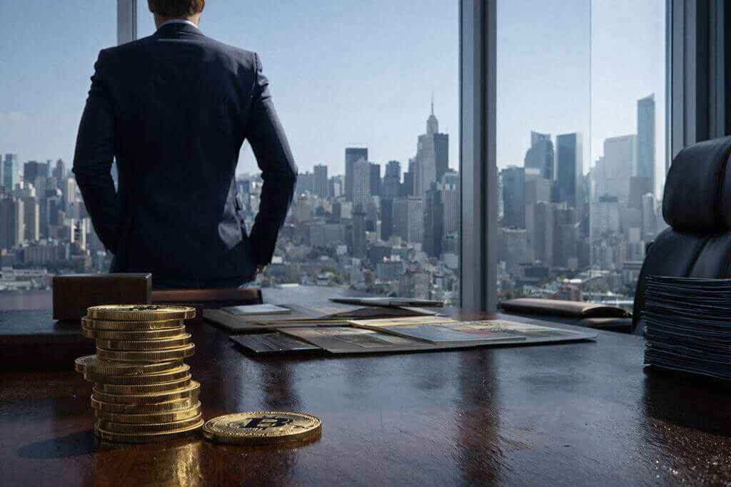 Stacked Bitcoin coins on a desk in a corporate office, reflecting Strategy’s $64B Bitcoin buying plan funded by high-yield financing and its potential impact on BTC price