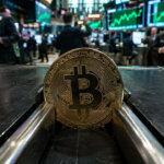 Bitcoin coin stuck in a narrow trading track on a busy exchange floor as green stock screens rally behind it, reflecting Bitcoin weakness during the S&P 500 melt-up