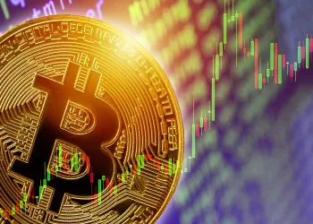 picture of a bitcoin with upwards candlestick chart behind it