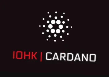 picture of Cardano developer IOHK next to the Cardano logo